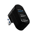 Black or white 4-port USB hub on a desktop next to a laptop and various peripherals.
