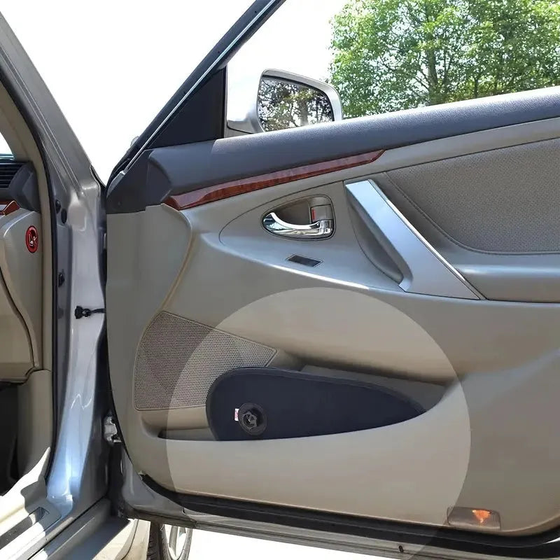 Black stretchy car side window sunshade with suction cups attached to protect a baby from sun.