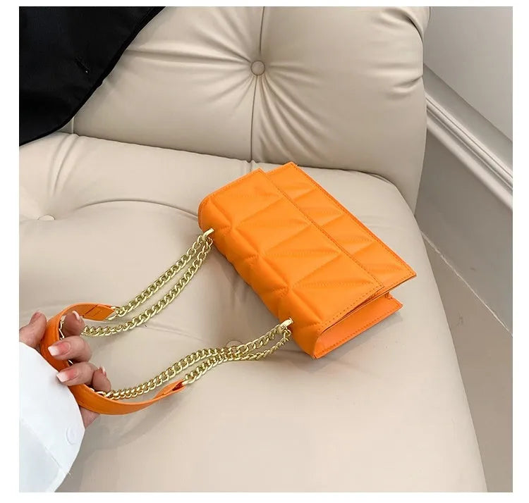 Small square PU chain crossbody bag in horizontal shape with spliced detail, available in five colours.