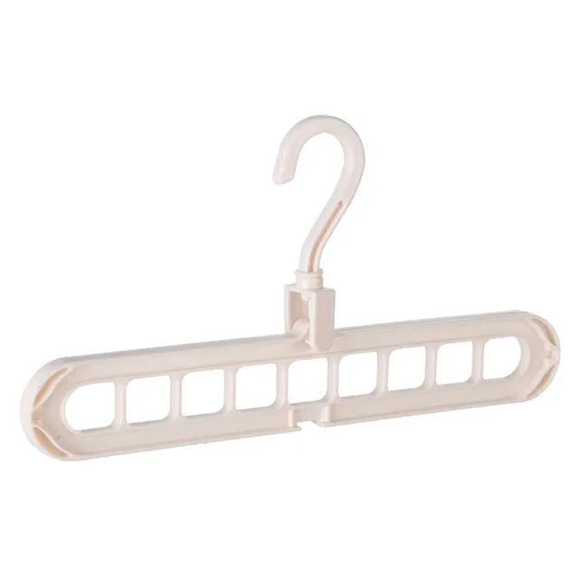 Plastic clothes hanger with rotating hook in pink and green colours on a rail.