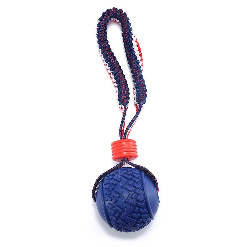 Blue rubber dog ball with natural rope attached for tug and chew play