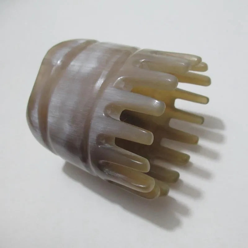 White buffalo horn comb with wide teeth and pointed tips for scalp massage and hair care
