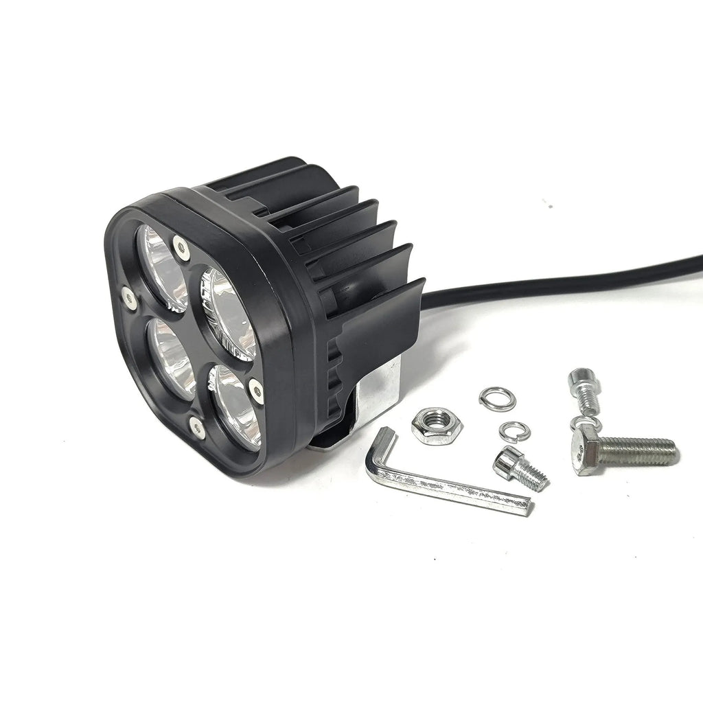 Four-eye automotive headlight with aluminium mounting base, showing four-leaf clover light pattern