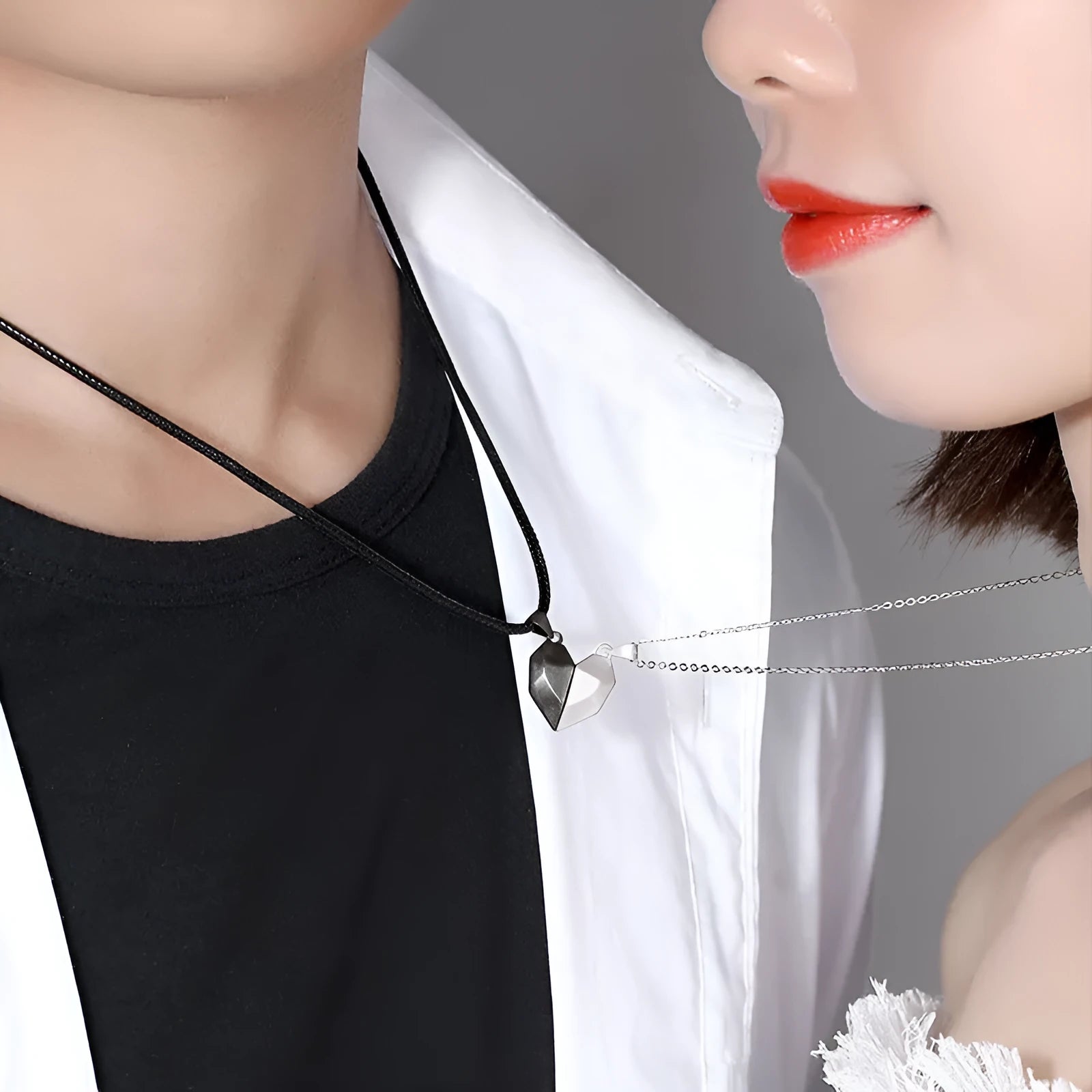 Gold-plated magnetic faceted heart pendant necklace in black and white on display