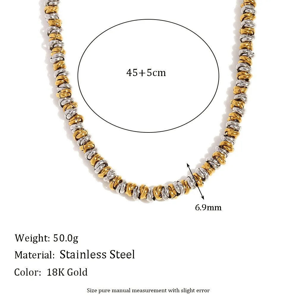 Gold tone electroplated stainless steel jewellery set with geometric shapes including earrings, bracelet and necklace