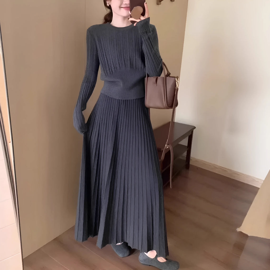 Dark grey knitted long dress suit with 3D pattern and collage stitching, shown with matching skirt.