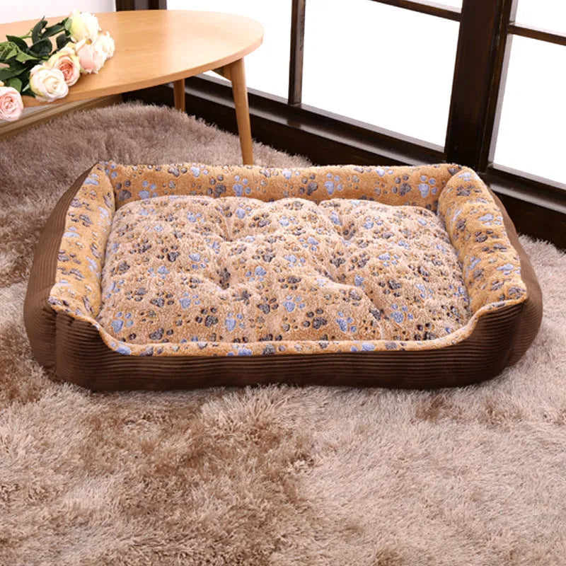 Beige plush dog bed with removable cover on a wooden floor, shown next to a small dog.