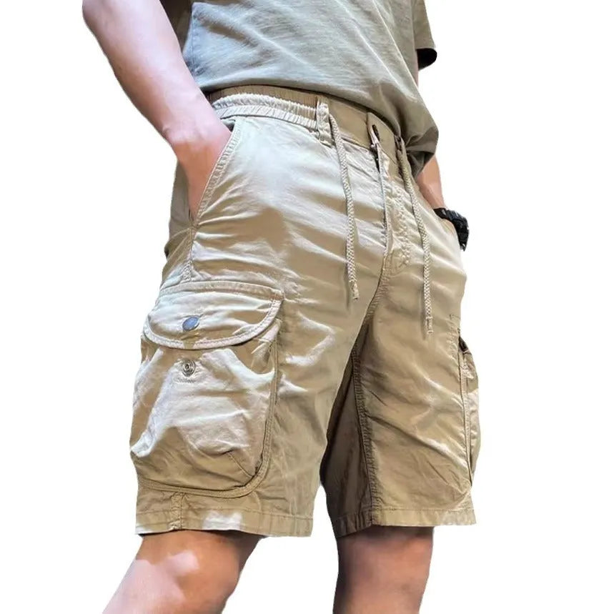 Loose straight-leg overalls pants in khaki with multiple cargo pockets on the legs.