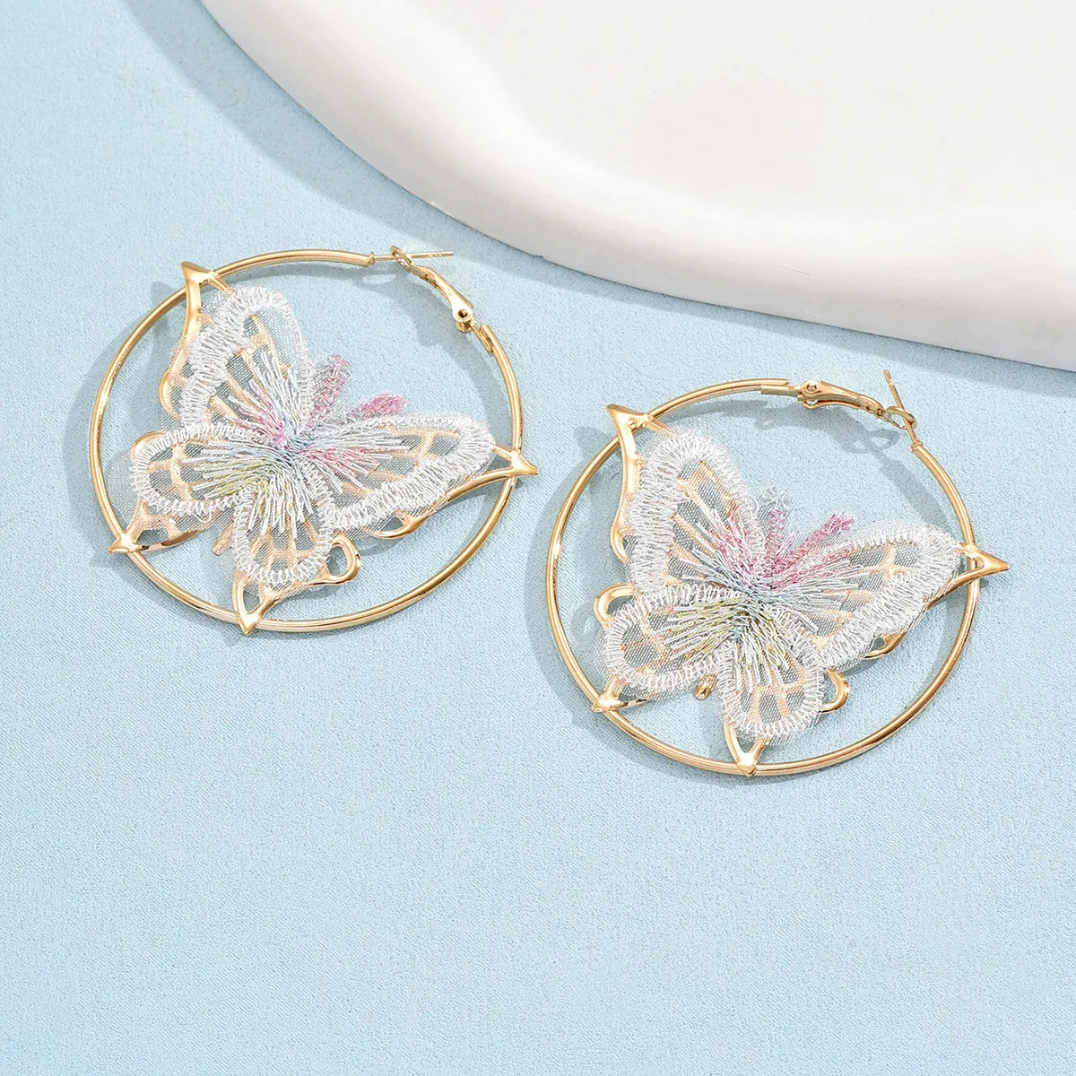 Gold butterfly clip-on earrings for women with geometric design and iron construction