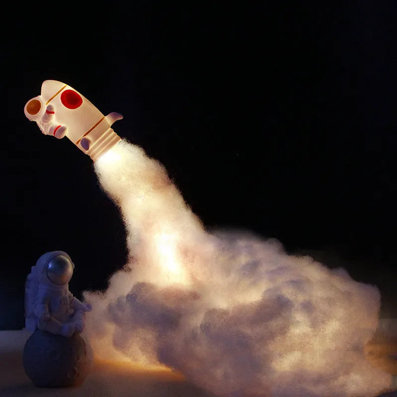 DIY astronaut rocket LED night light kit components including small model, straws, chassis, and string lights for assembly.