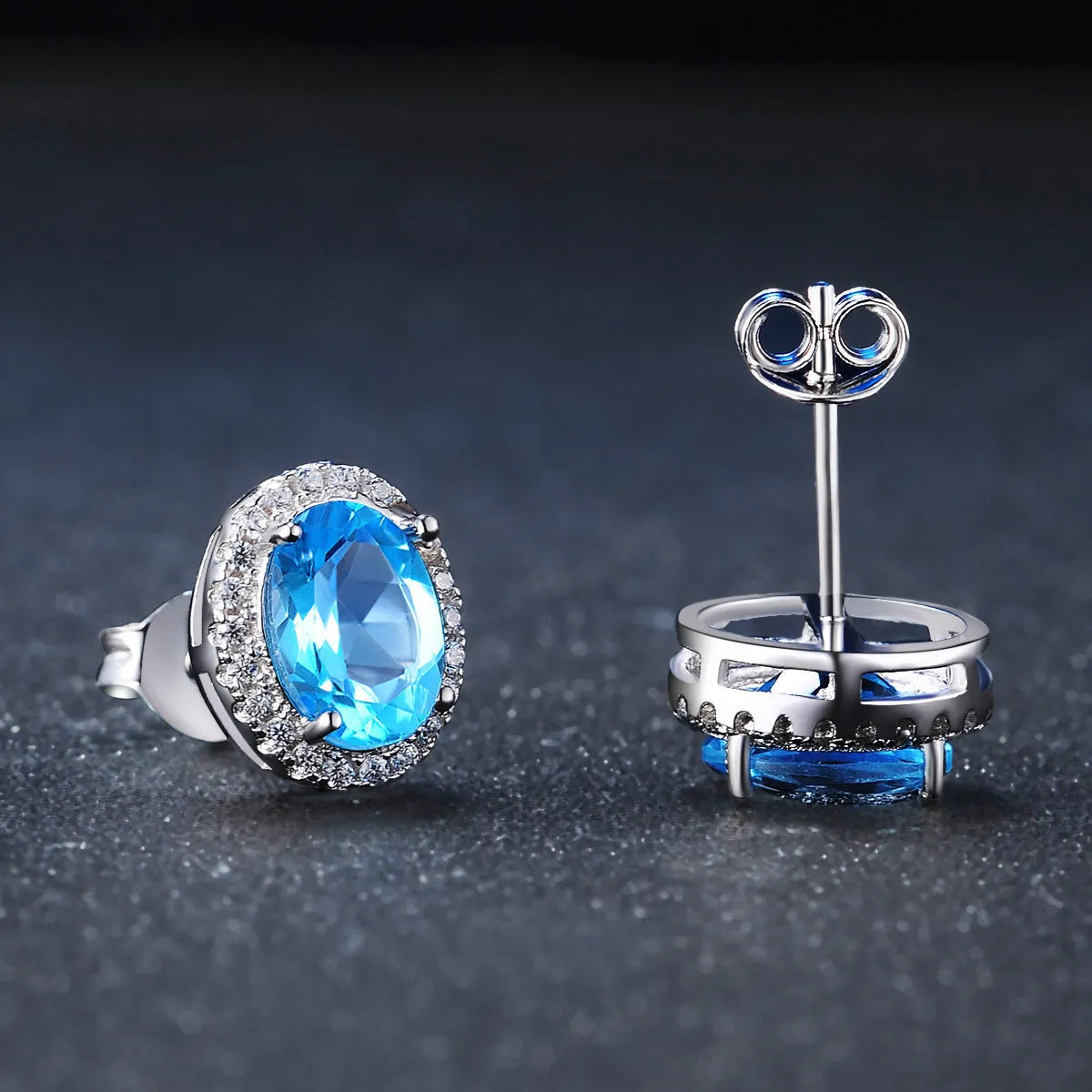 925 sterling silver jewellery set with blue topaz stones showing earrings, ring, pendant, and necklace with chain in geometric design
