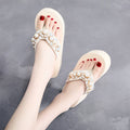Women's beige high-heeled flip-flop with cotton cloth upper, shown from the side.