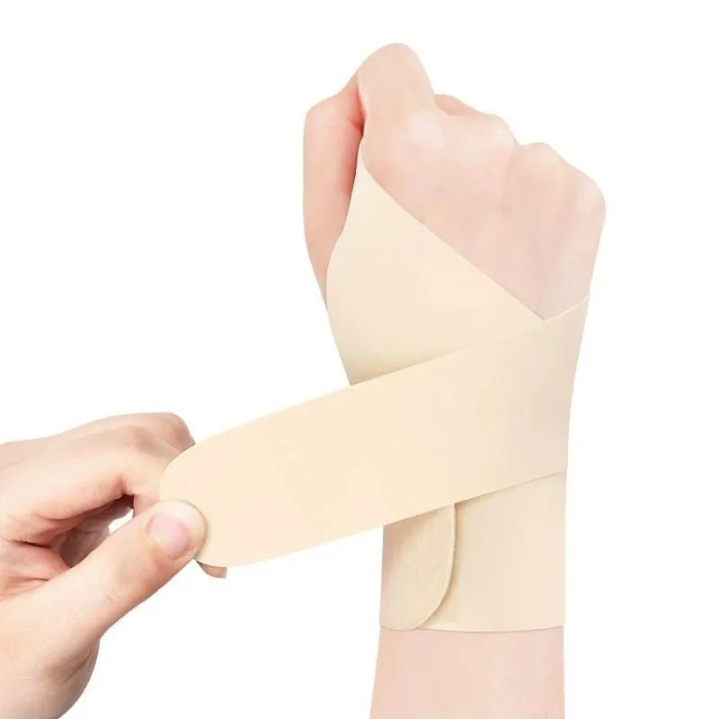 Black adjustable athletic wristguard shown on a wrist, suitable for badminton, tennis, and volleyball.