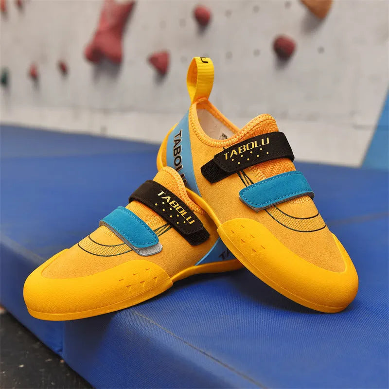 Black and red beginner rock climbing shoes with Velcro closure and rubber outsole