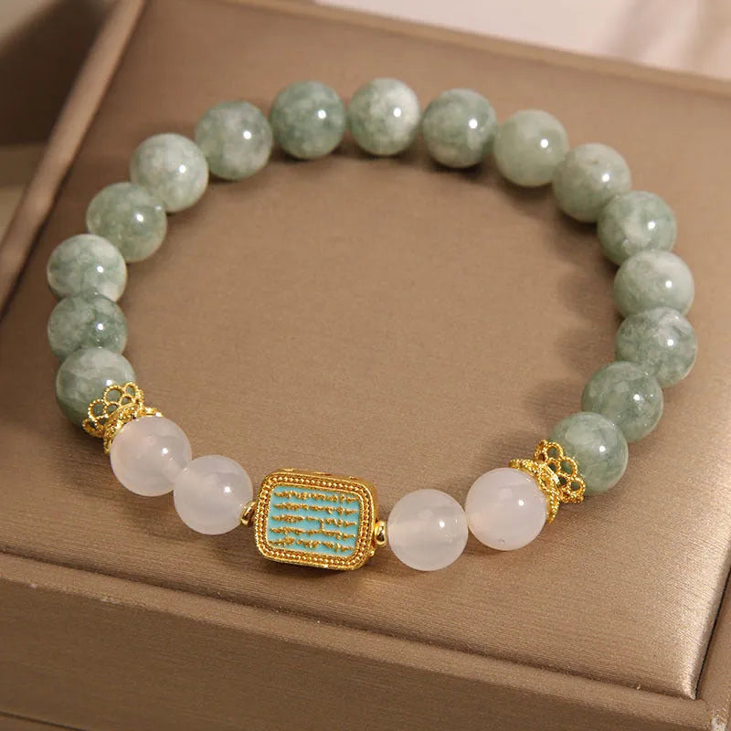 Women's oil green emerald crystal bracelet with five scriptural charms on wrist