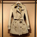Khaki women's double-breasted polyester trench coat with long flight sleeves.
