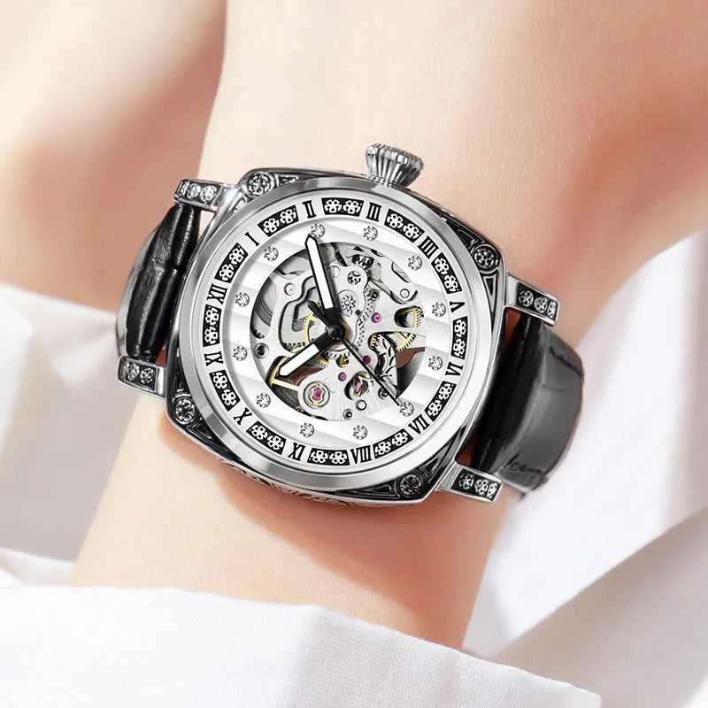 Men's black mechanical watch with luminous hands on a leather belt strap with needle detailing.