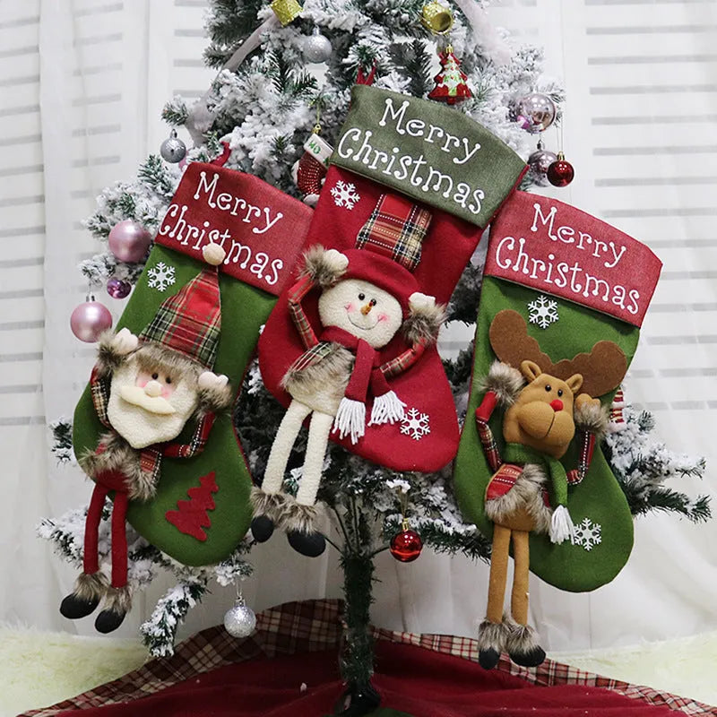 Set of three large Christmas stockings with Santa, Snowman, and Reindeer 3D designs hanging on a fireplace
