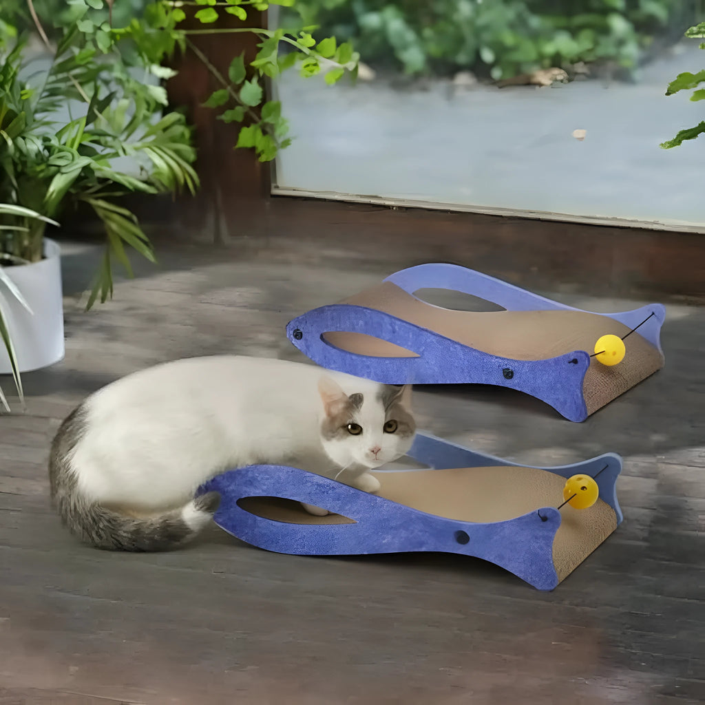 Blue fish-shaped cardboard cat scratcher lounge with wavy design and hanging bell ball toys