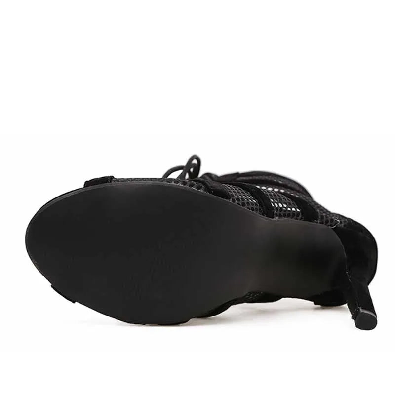 Black suede women's lace-up high heel shoes with a stiletto heel on a white background.