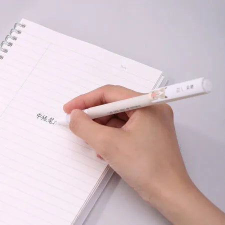 Black gel pen with full needle tube design on white surface, plastic body, cap on
