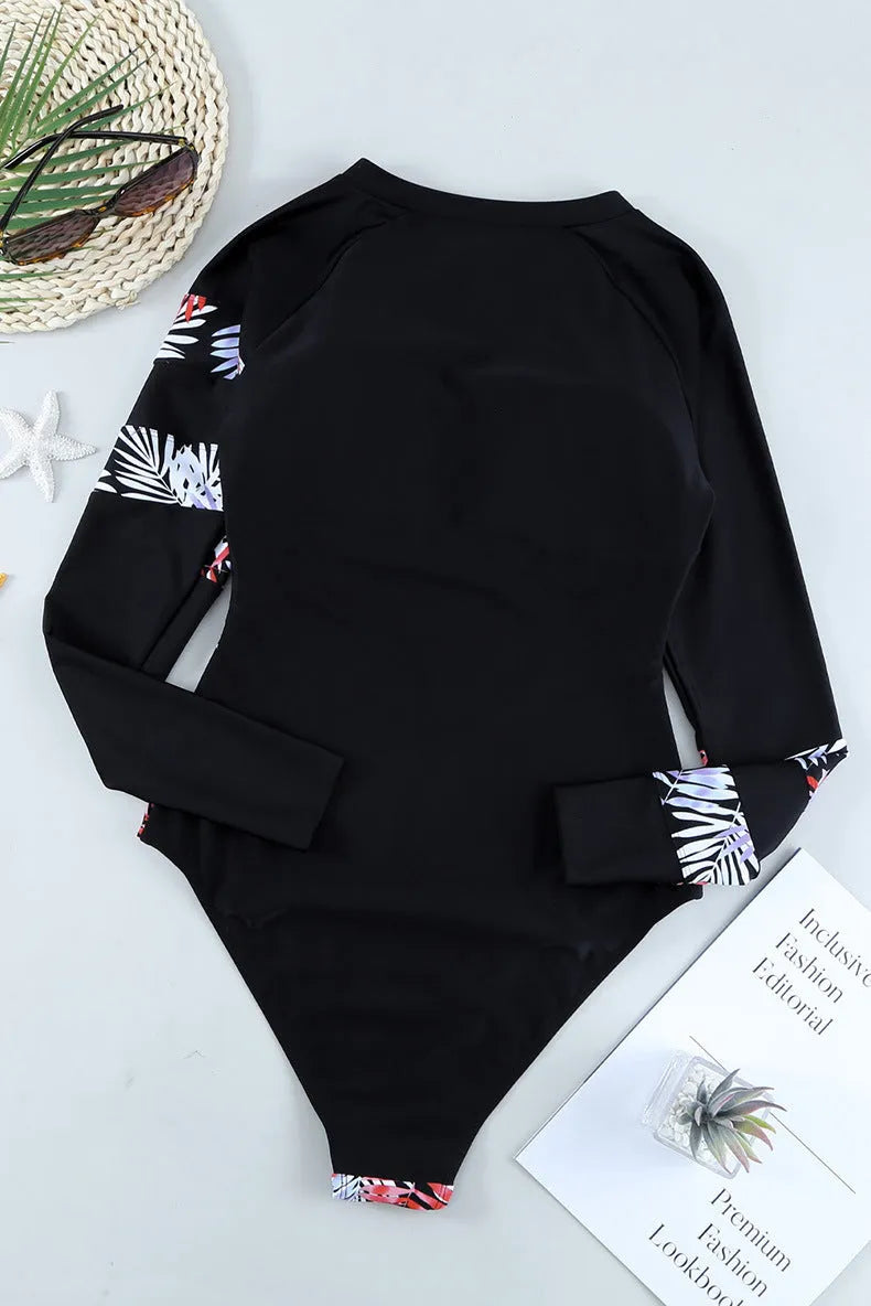 Light blue printed long sleeve women's one-piece wetsuit with triangle-cut leg, front view on white background