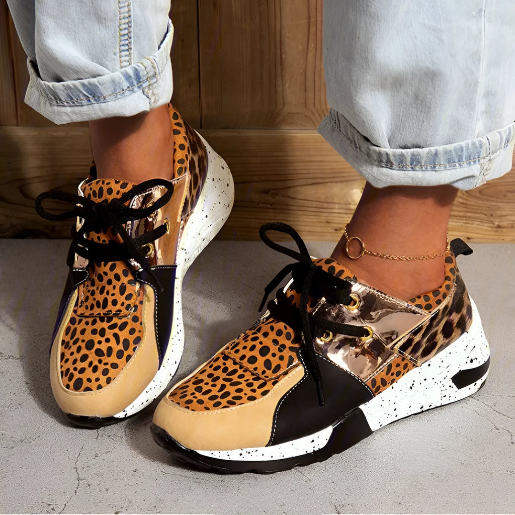 Women's suede flat sneakers with a wedge heel in leopard print, shown from the side.