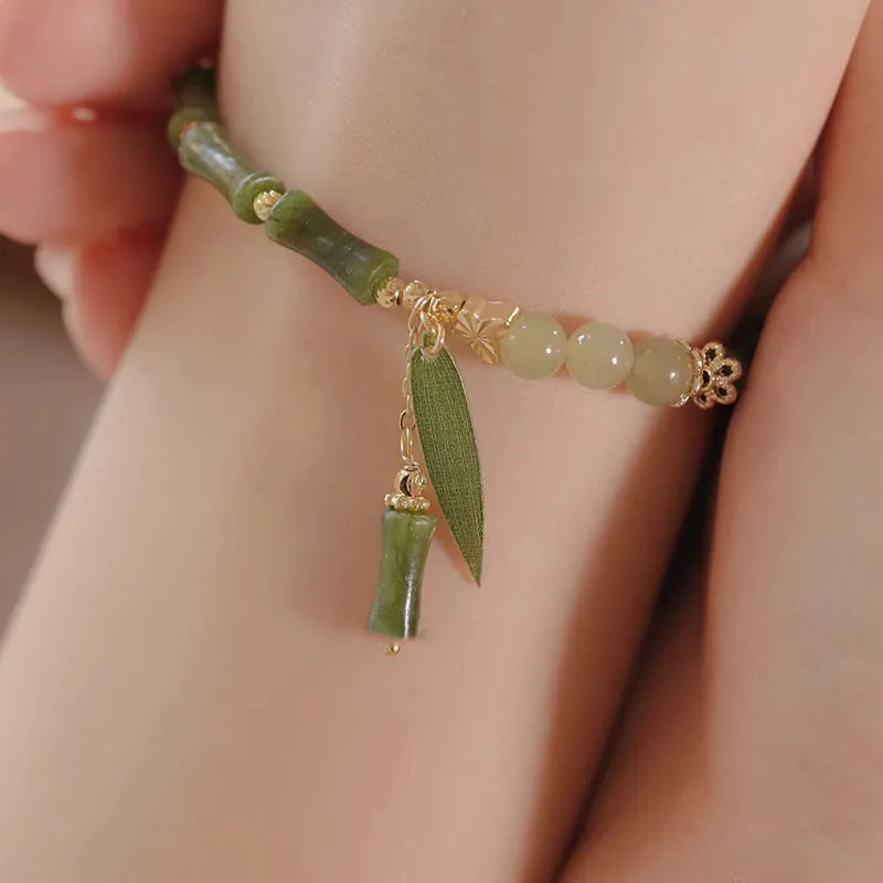Chinese style glass bead bracelet with bamboo leaf design and manual craftsmanship details.