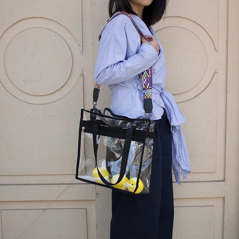 Women's transparent PVC front crossbody messenger bag with black side net pocket and double shoulder straps.