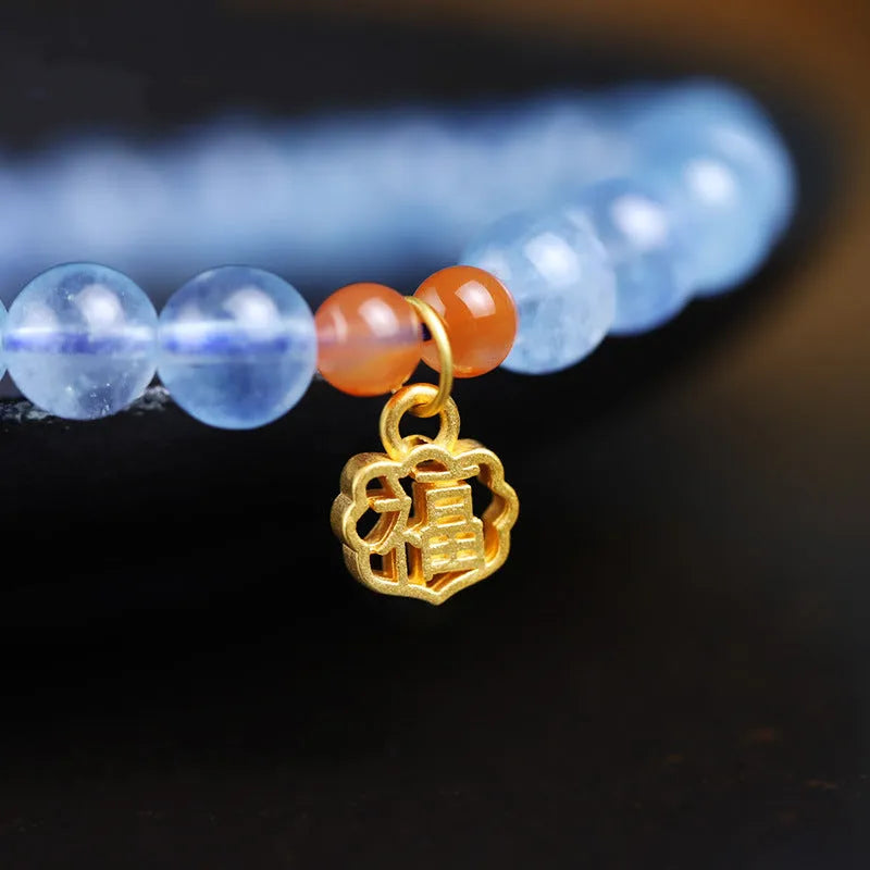 Ice translucent aquamarine crystal bracelet with 8mm round beads and sequins on a wrist.