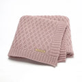 Solid colour infant hug blanket with three-dimensional lines, shown in one of five colour options.