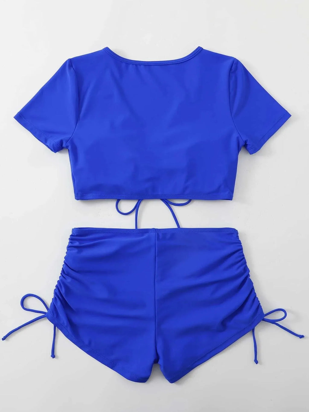 Women's dark green lace-up bow swimsuit top and shorts set for swimming.