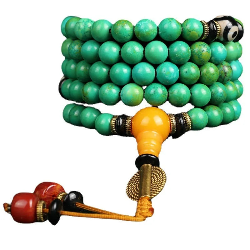 Natural turquoise bracelet with 108 round 8mm beads on a white background