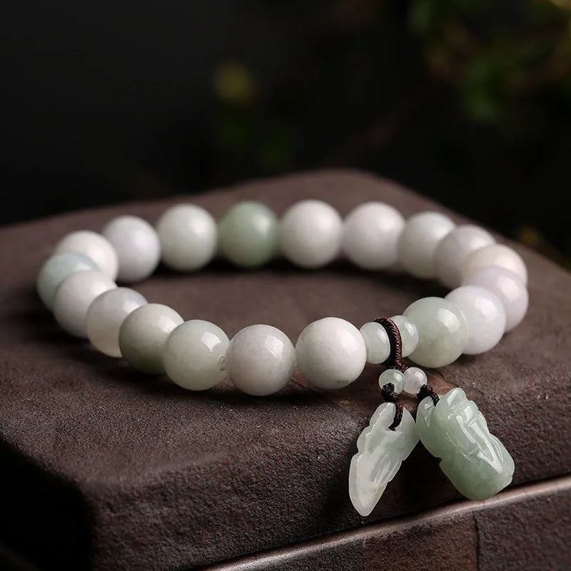 Jade hanging bracelet with Maitreya Buddha, apple, gourd, and money bag charms
