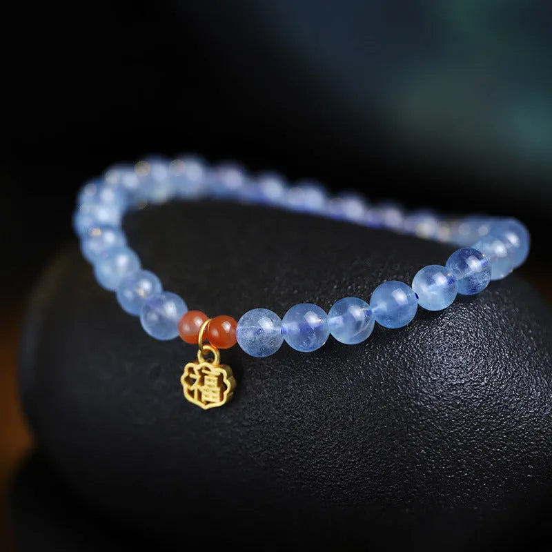 Ice translucent aquamarine crystal bracelet with 8mm round beads and sequins on a wrist.