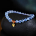 Ice translucent aquamarine crystal bracelet with 8mm round beads and sequins on a wrist.