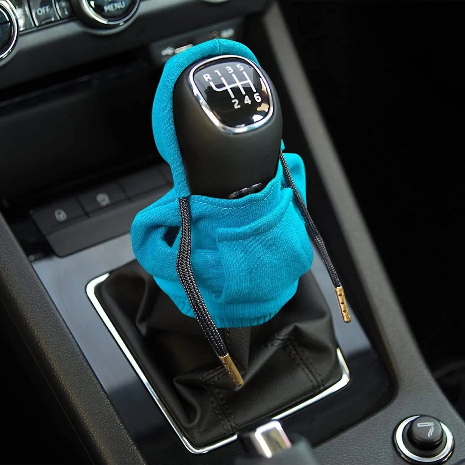 Cloth gear shift knob hoodie cover shown in multiple colours next to a car gear lever.