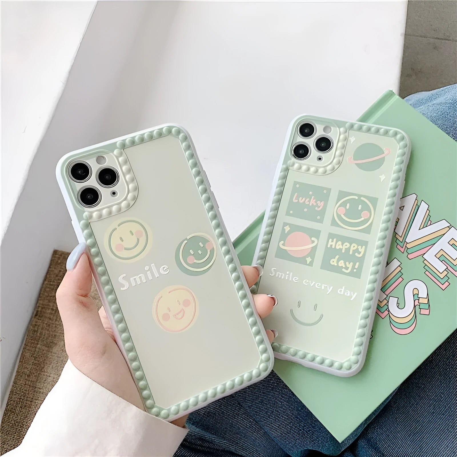 Green flexible TPU iPhone case with a geometric smiley face and polka dot frame design on the back.