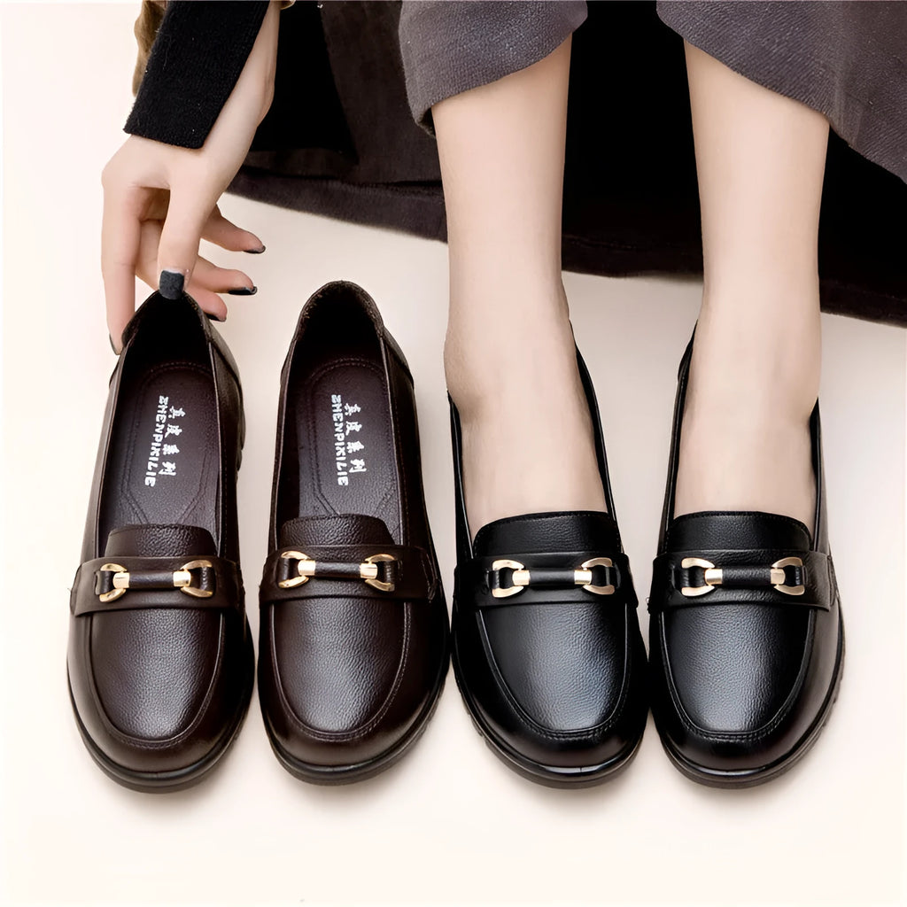 Black women's round-toe pumps with a low flat heel and elastic slip-on design.