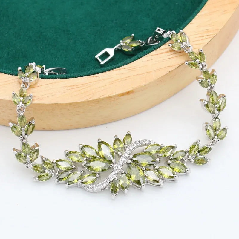 Retro jewellery set with plant pattern designs showing necklace, bracelet, earrings and ring pieces