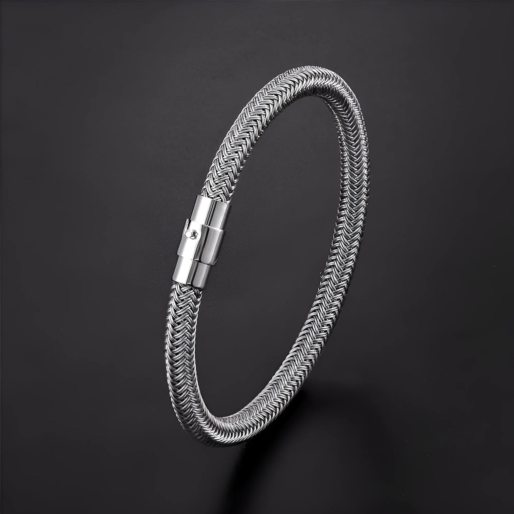 Geometric titanium steel wire bracelet with a magnetic clasp on a wrist, shown in a silver colour.