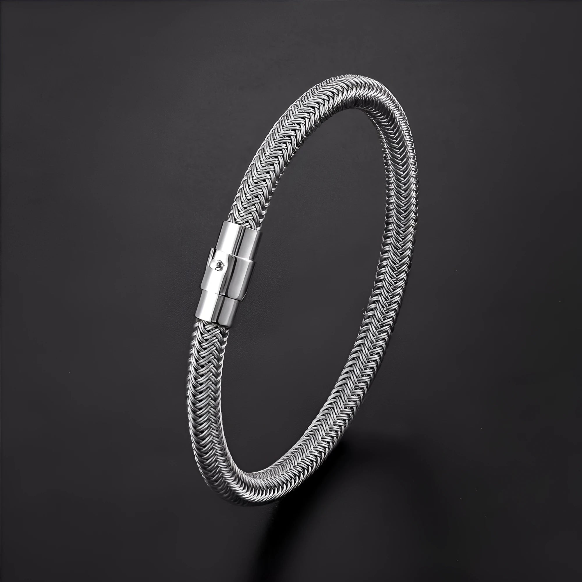 Geometric titanium steel wire bracelet with a magnetic clasp on a wrist, shown in a silver colour.