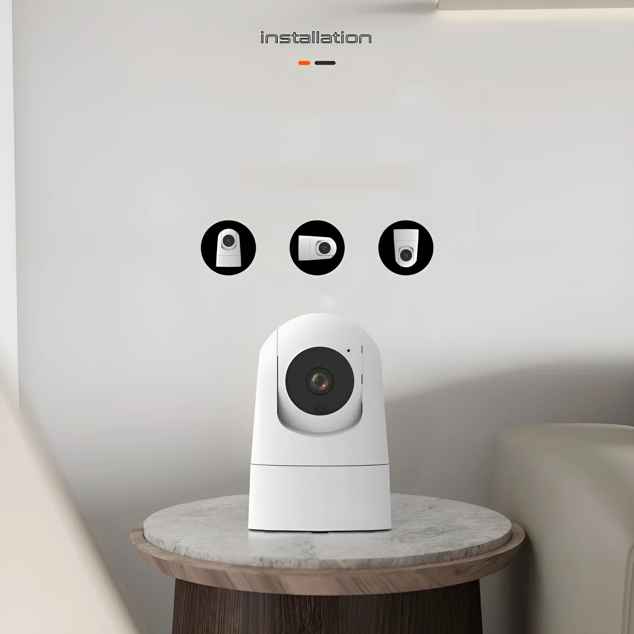 White square indoor security camera with lens and status light on front, shown next to its power adapter.