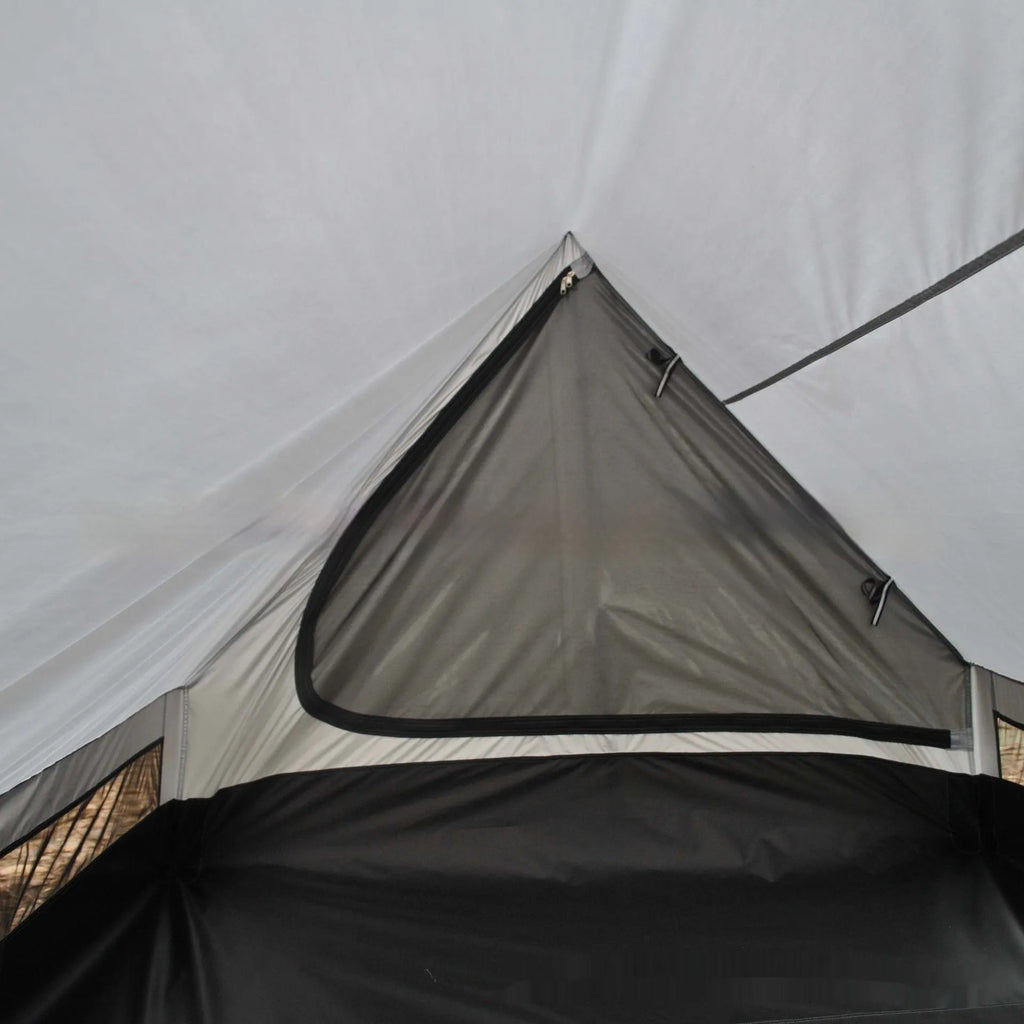 Brown A-line cabin tent pitched using hiking poles with aluminium ground nails and fluorescent wind ropes