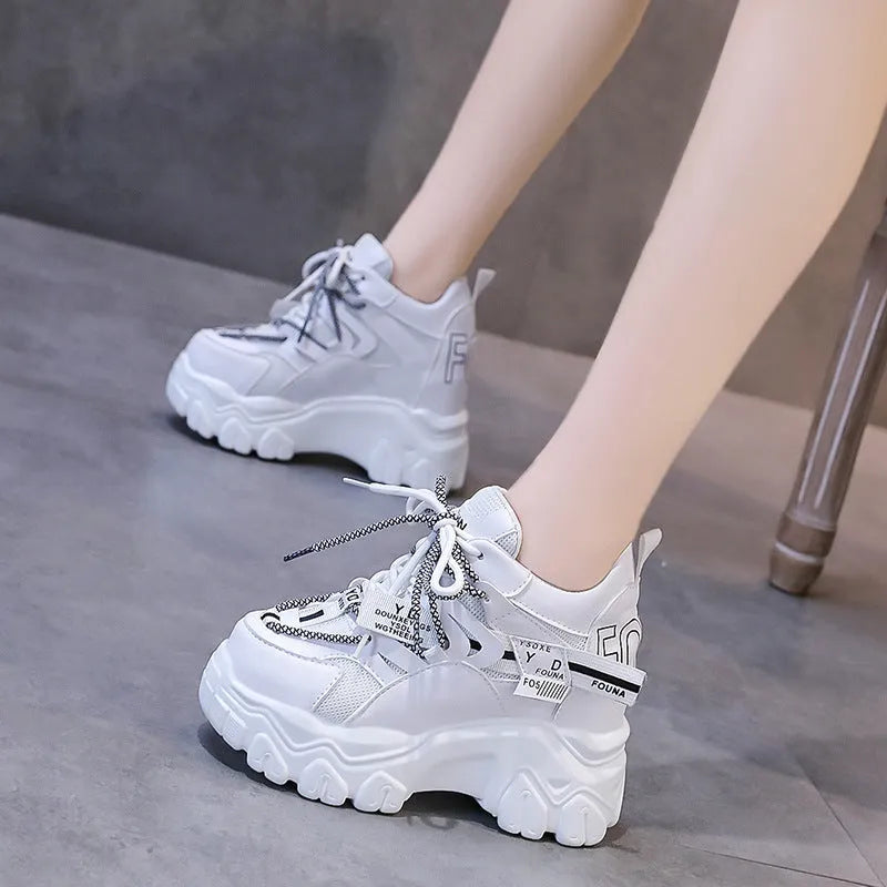 Women's white mesh platform sports shoes with cross strap and round toe on rubber sole.