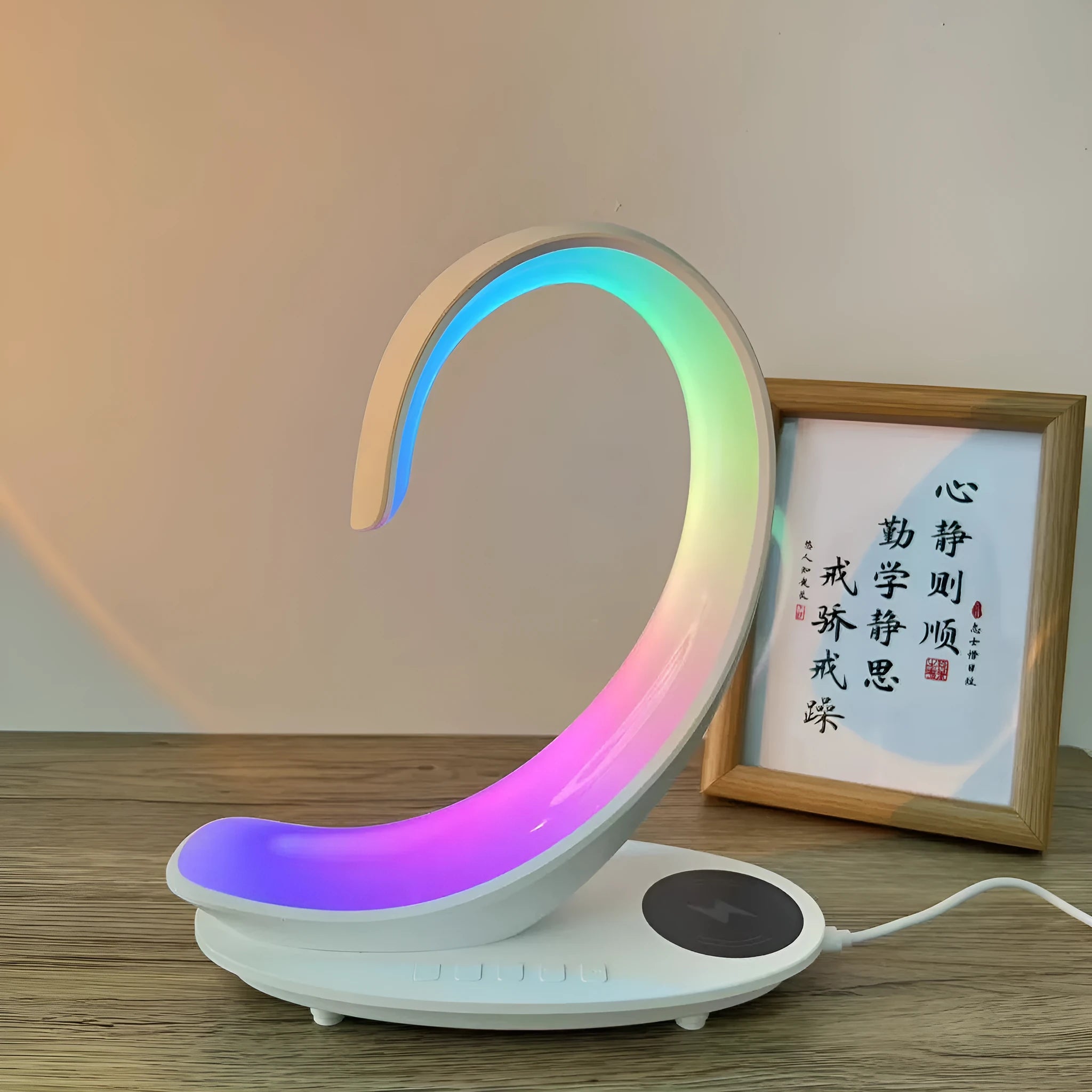 White swan-shaped desktop wireless charger with Bluetooth speaker and colourful ambient lighting