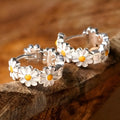 White daisy flower ring earrings with electroplated copper and platinum-accented gems.