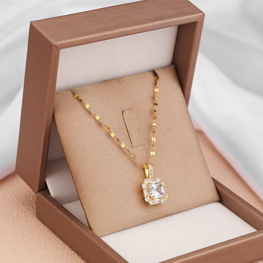 Gold geometric quadrilateral pendant necklace with mixed gemstones on a water wave chain.