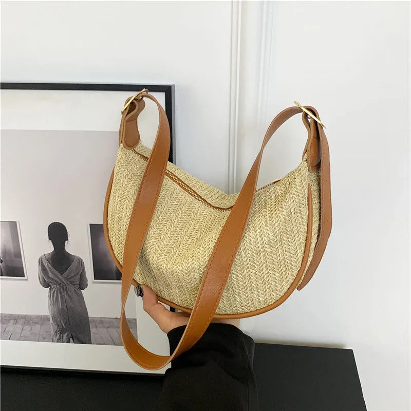Women's woven straw crossbody bag with adjustable strap and interior organisation compartments