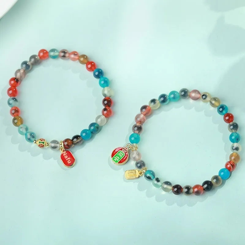 Women's geometric bracelet with colourful sugar heart agate beads and a detailed copper coin snake chain.